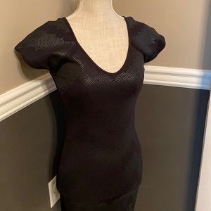 Armani Exchange, Small, black with black designs on it.